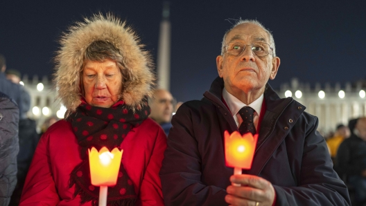 Catholic faithful attend a nightly rosary prayer for the health of Pope Francis in St. Peter's Square at the Vatican, Sunday, March 2, 2025. (AP Photo/Mosa'ab Elshamy)