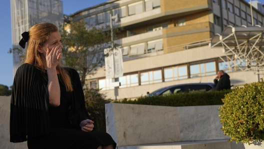 Michelle Van Asperen, of the Netherlands, wipes a tear as she prays for Pope Francis outside the Agostino Gemelli Polyclinic in Rome, Tuesday, March 4, 2025. (AP Photo/Gregorio Borgia)