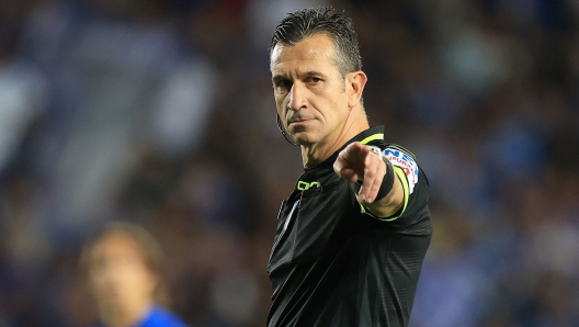 Referee Daniele Doveri making a gesture during a football match.