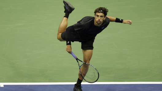 Lorenzo Musetti serves to Jannik Sinner during their US Open Quarterfinal match.
