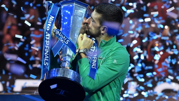 Novak Djokovic of Serbia celebrates with the trophy after winning the final against Jannik Sinner of Italy at the Nitto ATP Finals tennis tournament in Turin, Italy, 19 November 2023.  ANSA/ALESSANDRO DI MARCO