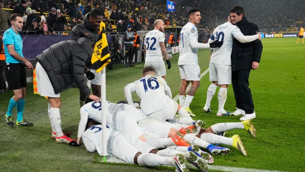 Inter Milan's players celebrate with Inter Milan's head coach Cristian Chivu, right, their second goal by Andy Diouf during the Champions League opening phase soccer match between Borussia Dortmund and Inter Milan in Dortmund, Germany, Wednesday, Jan. 28, 2026. (AP Photo/Martin Meissner)