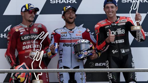 Race winner, Italian rider Enea Bastianini of the Gresini Racing MotoGP, center, poses with second placed Australian rider Jack Miller of the Ducati Lenovo Team, left, and third placed Spain's rider Aleix Espargaro of the Aprilia Racing after the MotoGP race of the French Motorcycle Grand Prix at the Le Mans racetrack, in Le Mans, France, Sunday, May 15, 2022. (AP Photo/Jeremias Gonzalez)