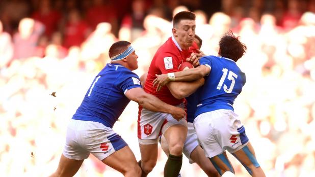 CARDIFF, WALES - MARCH 19: Josh Adams of Wales is tackled by Ange Capuozzo of Italy during the Six Nations Rugby match between Wales and Italy at Principality Stadium on March 19, 2022 in Cardiff, Wales. (Photo by Mike Hewitt/Getty Images)