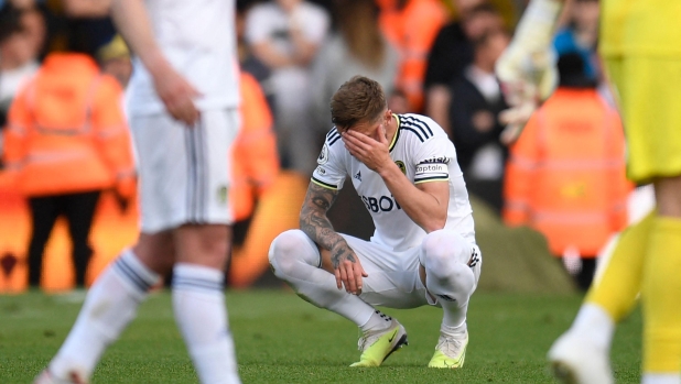 Leeds United's English-born Scottish defender Liam Cooper reacts to their defeat on the pitch after the English Premier League football match between Leeds United and Tottenham Hotspur at Elland Road in Leeds, northern England on May 28, 2023. Tottenham won the game 4-1, Leeds are relegated to the Championship. (Photo by Oli SCARFF / AFP) / RESTRICTED TO EDITORIAL USE. No use with unauthorized audio, video, data, fixture lists, club/league logos or 'live' services. Online in-match use limited to 120 images. An additional 40 images may be used in extra time. No video emulation. Social media in-match use limited to 120 images. An additional 40 images may be used in extra time. No use in betting publications, games or single club/league/player publications. /