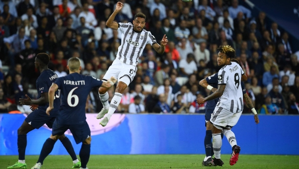 Juventus' Brazilian defender Danilo (C) jumps to intercept the ball as Paris Saint-Germain's Italian midfielder Marco Verratti (L) looks on during the UEFA Champions League Group H first leg football match between Paris Saint-Germain (PSG) and Juventus at Parc des Princes Stadium in Paris, on September 6, 2022. (Photo by FRANCK FIFE / AFP)