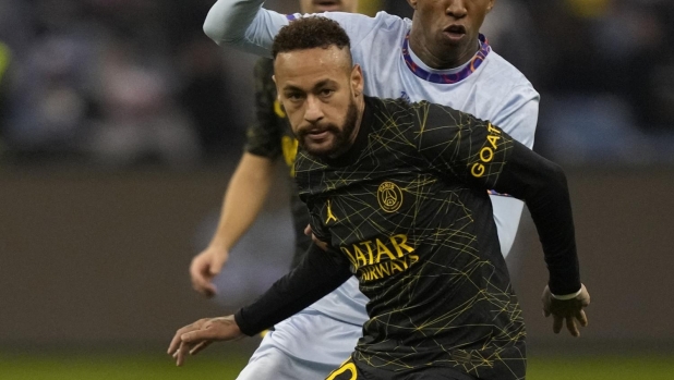 PSG's Neymar challenges for the ball with Saudi Season Team's Talisca playing for a combined XI of Saudi Arabian teams Al Nassr during a friendly soccer match, at the King Saud University Stadium, in Riyadh, Saudi Arabia, Thursday, Jan. 19, 2023. (AP Photo/Hussein Malla)