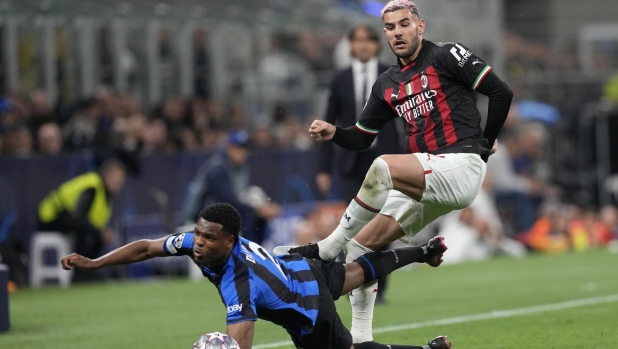 Inter Milan's Denzel Dumfries is challenged by AC Milan's Theo Hernandez, right, during the Champions League semifinal second leg soccer match between Inter Milan and AC Milan at the San Siro stadium in Milan, Italy, Tuesday, May 16, 2023. (AP Photo/Antonio Calanni)