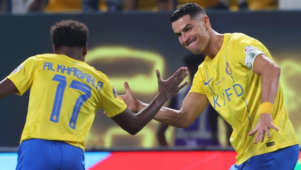 Nassr's Portuguese forward #07 Cristiano Ronaldo celebrates scoring with Nassr's Saudi midfielder #17 Abdullah al-Khaibari during the Saudi Pro League football match between Al-Nassr and Al-Ahli at the King Saud University Stadium in Riyadh, on September 22, 2023. (Photo by Fayez NURELDINE / AFP)