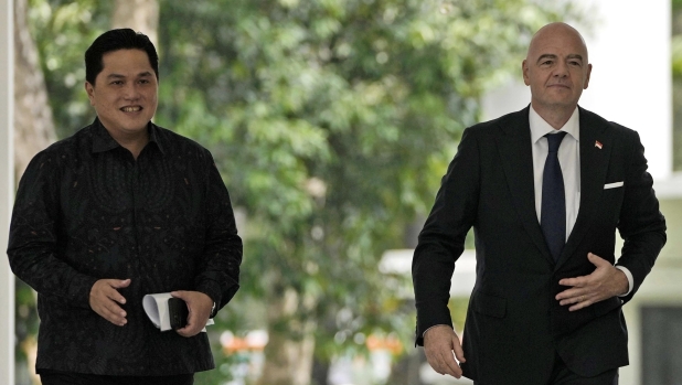 FILE - FIFA President Gianni Infantino, right, walks with Minister for State Owned Enterprises Erick Thohir upon arrival for a meeting with Indonesian President Joko Widodo at Merdeka Palace in Jakarta, Indonesia, Tuesday, Oct. 18, 2022. Indonesian soccer federation leader Erick Thohir says it now supports Saudi Arabia's bid to host the 2034 World Cup. (AP Photo/Achmad Ibrahim, File)