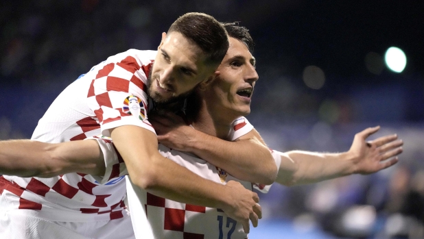 Croatia's Ante Budimir, right, celebrates after scoring against Armenia during the Euro 2024 group D qualifying soccer match between Croatia and Armenia at the Maksimir Stadium in Zagreb, Croatia, Tuesday, Nov. 21, 2023. (AP Photo/Darko Bandic)   Associated Press/LaPresse Only Italy and Spain