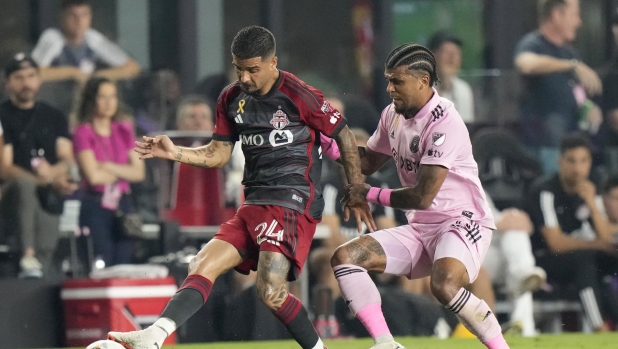 Toronto FC forward Lorenzo Insigne (24) passes past Inter Miami defender DeAndre Yedlin during the first half of an MLS soccer match, Wednesday, Sept. 20, 2023, in Fort Lauderdale, Fla. (AP Photo/Wilfredo Lee)