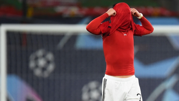 TOPSHOT - Manchester United's Portuguese defender #20 Diogo Dalot reacts after the UEFA Champions League group A football match between Manchester United and FC Bayern Munich at Old Trafford stadium in Manchester, north west England, on December 12, 2023. (Photo by PETER POWELL / AFP)