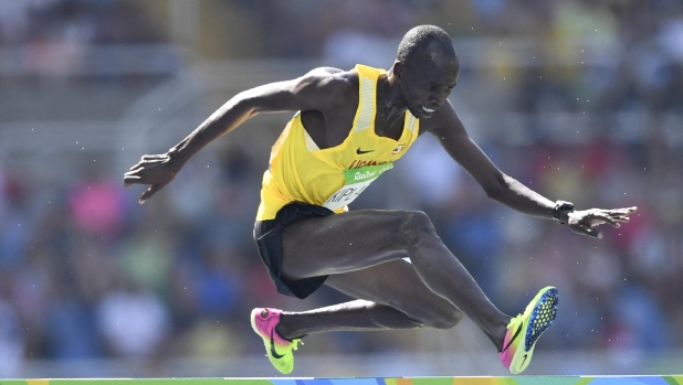 (FILES) Uganda's Benjamin Kiplagat competes in the Men's 3000m Steeplechase Round 1 during the athletics event at the Rio 2016 Olympic Games at the Olympic Stadium in Rio de Janeiro on August 15, 2016. Ugandan athlete Benjamin Kiplagat has been found dead in Kenya, police said on December 31, 2023, with local media reports saying he had been murdered. (Photo by Fabrice COFFRINI / AFP)
