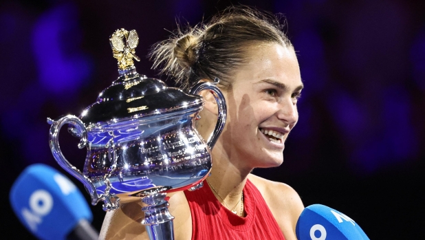 Belarus' Aryna Sabalenka speaks while holding the Daphne Akhurst Memorial Cup after victory against China's Zheng Qinwen during their women's singles final match on day 14 of the Australian Open tennis tournament in Melbourne on January 27, 2024. (Photo by David GRAY / AFP) / -- IMAGE RESTRICTED TO EDITORIAL USE - STRICTLY NO COMMERCIAL USE --