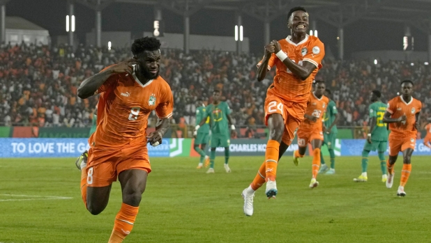 Ivory Coast's Franck Kessie, left, celebrates after scoring his side's opening goal during the African Cup of Nations round of 16 soccer match between Senegal and Ivory Coast, at the Charles Konan Banny stadium in Yamoussoukro, Ivory Coast, Monday, Jan. 29, 2024. (AP Photo/Themba Hadebe)