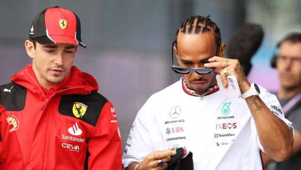 NORTHAMPTON, ENGLAND - JULY 06: Charles Leclerc of Monaco and Ferrari and Lewis Hamilton of Great Britain and Mercedes talk in the Paddock during previews ahead of the F1 Grand Prix of Great Britain at Silverstone Circuit on July 06, 2023 in Northampton, England. (Photo by Ryan Pierse/Getty Images)