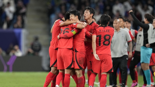 South Korea's Son Heung-min, centre, celebrates with teammates after scoring his side's second goal during the Asian Cup quarterfinal soccer match between Australia and South Korea at Al Janoub Stadium in Al Wakrah, Qatar, Friday, Feb. 2, 2024. (AP Photo/Aijaz Rahi)