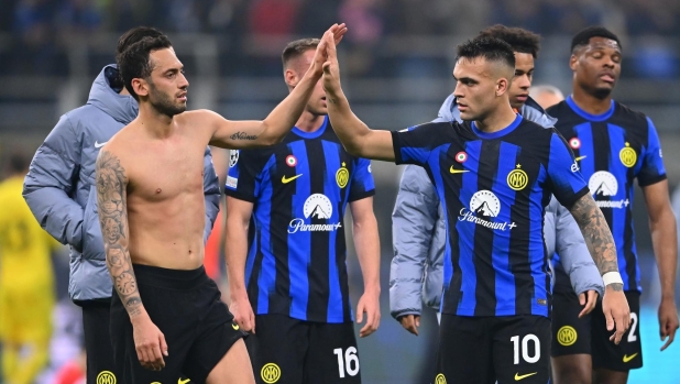 MILAN, ITALY - FEBRUARY 20:  Hakan Calhanoglu and Lautaro Martinez of FC Internazionale celebrates the win at the end of the UEFA Champions League 2023/24 round of 16 first leg match between FC Internazionale and Atletico Madrid at Stadio Giuseppe Meazza on February 20, 2024 in Milan, Italy. (Photo by Mattia Pistoia - Inter/Inter via Getty Images)
