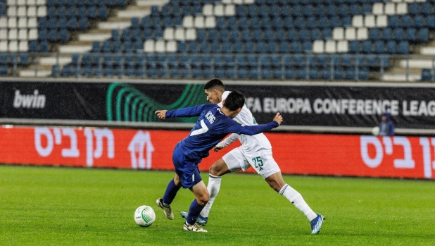 Gent's Huyun-Seok Hong and Maccabi's Anan Khalaily fight for the ball during a soccer match between Belgian KAA Gent and Israeli Maccabi Haifa, on Wednesday 21 February 2024 in Gent, the return leg of the play offs phase of the UEFA Conference League competition. The first leg ended in a 1-0 Maccabi win. BELGA PHOTO KURT DESPLENTER (Photo by KURT DESPLENTER / BELGA MAG / Belga via AFP)