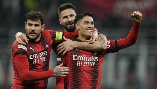 AC Milan's Tijjani Reijnders, right, celebrates with his teammates Theo Hernandez, left, and Olivier Giroud after scoring his side's second goal during the Europa League round of 16 first leg soccer match between AC Milan and Slavia Praha at the San Siro Stadium, in Milan, Italy, Thursday, March 7, 2024. (AP Photo/Antonio Calanni)