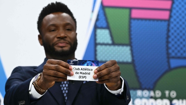 Former Nigerian footballer John Obi Mikel holds the paper slip of Atletico de Madrid during the 2023-2024 UEFA Champions League football tournament quarter-finals and semi-finals draw at the House of European Football in Nyon, on March 15, 2024. (Photo by Fabrice COFFRINI / AFP)