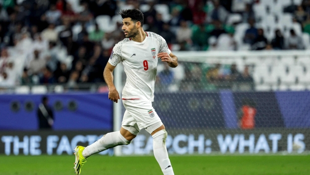 Iran's forward #09 Mehdi Taremi runs with the ball during the Qatar 2023 AFC Asian Cup Group C football match between Iran and United Arab Emirates at Education City Stadium in al-Rayyan, west of Doha, on January 23, 2024. (Photo by KARIM JAAFAR / AFP)