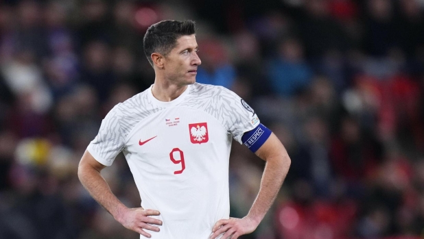 Poland's Robert Lewandowski stands on the pitch at the end of the Euro 2024 Group E qualifying soccer match between Czech Republic and Poland at the Sinobo stadium in Prague, Czech Republic, Friday March 24, 2023. (AP Photo/Petr David Josek)