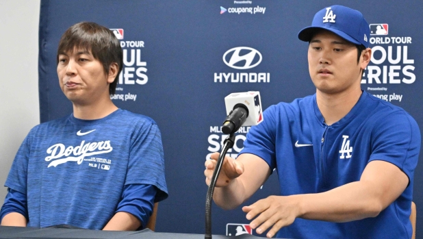 This picture taken on March 16, 2024 shows Los Angeles Dodgers' Shohei Ohtani (R) and his interpreter Ippei Mizuhara (L) attending a press conference at Gocheok Sky Dome in Seoul ahead of the 2024 MLB Seoul Series baseball game between Los Angeles Dodgers and San Diego Padres. The Los Angeles Dodgers said on March 21 they had fired Shohei Ohtani's interpreter after the Japanese baseball star's representatives claimed he had been the victim of "a massive theft" reported to involve millions of dollars. (Photo by Jung Yeon-je / AFP)