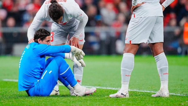 Switzerland's defender Ricardo Rodriguez (L, top) talks with Switzerland's goalkeeper Yann Sommer (L) sitting on the pitch during the friendly football match between Denmark and Switzerland in Copenhagen, Denmark, on March 23, 2024. (Photo by Liselotte Sabroe / Ritzau Scanpix / AFP) / Denmark OUT