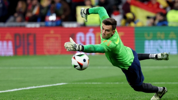 Brazil's goalkeeper #01 Bento jumps for the ball as he warms up prior to the international friendly football match between Spain and Brazil at the Santiago Bernabeu stadium in Madrid, on March 26, 2024. Spain arranged a friendly against Brazil at the Santiago Bernabeu under the slogan "One Skin" to help combat racism. (Photo by Pierre-Philippe MARCOU / AFP)