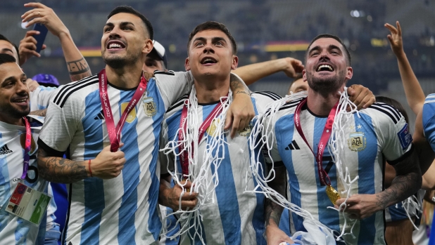 From left, Argentina's Leandro Paredes, Paulo Dybala and Rodrigo De Paul celebrate winning the World Cup final soccer match between Argentina and France at the Lusail Stadium in Lusail, Qatar, Sunday, Dec.18, 2022. (AP Photo/Manu Fernandez)