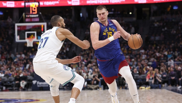 DENVER, COLORADO - MARCH 29: Nikola Jokic #15 of the Denver Nuggets drives against Rudy Gobert #27 of the Minnesota Timberwolves during the fourth quarter at Ball Arena on March 29, 2024 in Denver, Colorado. NOTE TO USER: User expressly acknowledges and agrees that, by downloading and or using this photograph, User is consenting to the terms and conditions of the Getty Images License Agreement.   Matthew Stockman/Getty Images/AFP (Photo by MATTHEW STOCKMAN / GETTY IMAGES NORTH AMERICA / Getty Images via AFP)
