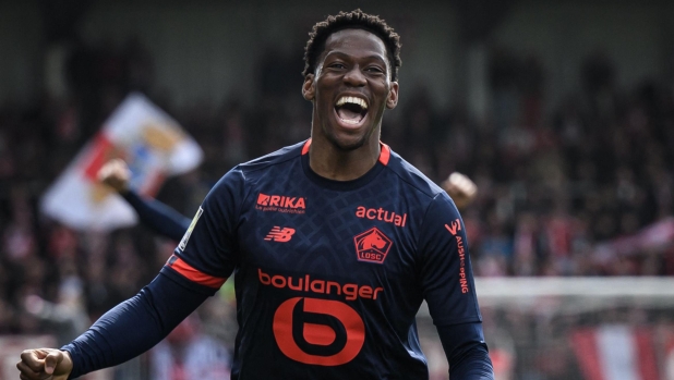 Lille's Canadian forward #09 Jonathan David reacts after scoring his team's first goal during the French L1 football match between Stade Brestois 29 (Brest) and Lille OSC at Stade Francis-Le Ble in Brest, western France, on March 17, 2024. (Photo by LOIC VENANCE / AFP)