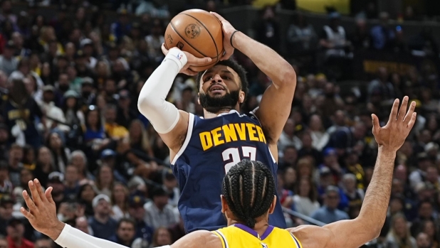 Denver Nuggets guard Jamal Murray, top, shoots for a basket over Los Angeles Lakers guard Gabe Vincent (7) in the first half of Game 5 of an NBA basketball first-round playoff series Monday, April 29, 2024, in Denver. (AP Photo/David Zalubowski)