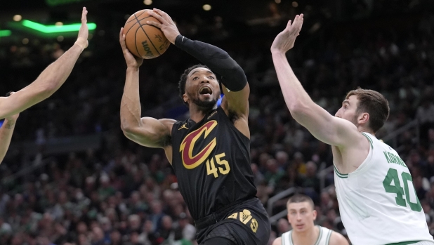 Cleveland Cavaliers guard Donovan Mitchell (45) shoots as Boston Celtics center Luke Kornet (40) defends during the second half of Game 2 of an NBA basketball second-round playoff series Thursday, May 9, 2024, in Boston. (AP Photo/Steven Senne)