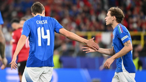 Italy's forward #14 Federico Chiesa shakes hands with Italy's midfielder #18 Nicolo Barella (R) during the UEFA Euro 2024 Group B football match between Italy and Albania at the BVB Stadion in Dortmund on June 15, 2024. (Photo by Alberto PIZZOLI / AFP)