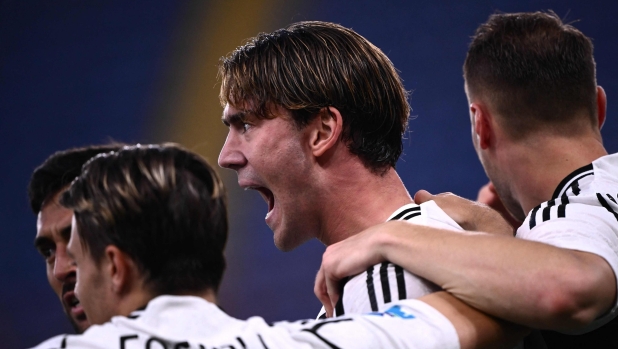 Juventus Serbian forward #09 Dusan Vlahovic celebrates with teammates after scoring a goal during the Italian Serie A football match bwteeen Genoa and Juventus at the Luigi-Ferraris Stadium, in Genoa on September 28, 2024. (Photo by MARCO BERTORELLO / AFP)