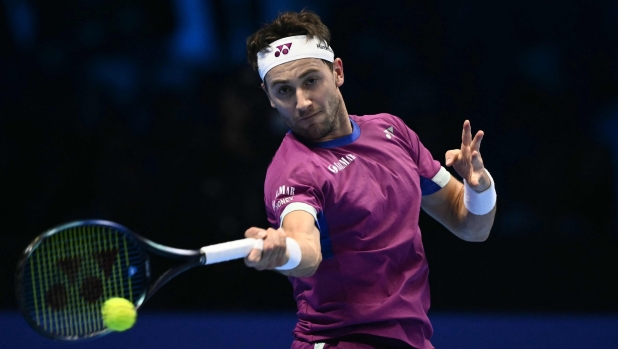 Norway's Casper Ruud hits a return to Russia's Andrey Rublev during their match at the ATP Finals tennis tournament in Turin on November 15, 2024. (Photo by Marco BERTORELLO / AFP)