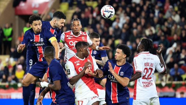 Paris Saint-Germain's Portuguese forward #09 Goncalo Ramos (2nd-L) heads the ball to score his team's third goal during the French L1 football match between AS Monaco and Paris Saint-Germain at the Louis II Stadium (Stade Louis II) in the Principality of Monaco on December 18, 2024. (Photo by Valery HACHE / AFP)