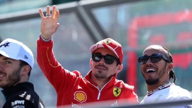 MELBOURNE, AUSTRALIA - MARCH 24: Charles Leclerc of Monaco and Ferrari and Lewis Hamilton of Great Britain and Mercedes talk on the drivers parade prior to the F1 Grand Prix of Australia at Albert Park Circuit on March 24, 2024 in Melbourne, Australia. (Photo by Robert Cianflone/Getty Images)