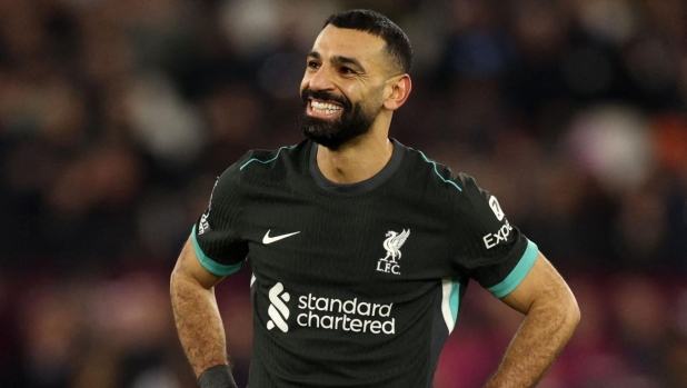 Liverpool's Egyptian striker #11 Mohamed Salah reacts during the English Premier League football match between West Ham United and Liverpool at the London Stadium, in London on December 29, 2024. (Photo by Adrian Dennis / AFP) / RESTRICTED TO EDITORIAL USE. No use with unauthorized audio, video, data, fixture lists, club/league logos or 'live' services. Online in-match use limited to 120 images. An additional 40 images may be used in extra time. No video emulation. Social media in-match use limited to 120 images. An additional 40 images may be used in extra time. No use in betting publications, games or single club/league/player publications. /