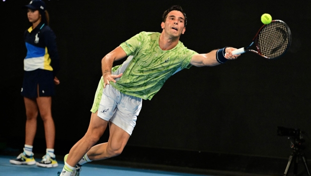 Italy?s Matteo Gigante hits a return against France's Ugo Humbert during their men's singles match on day one of the Australian Open tennis tournament in Melbourne on January 12, 2025. (Photo by Yuichi YAMAZAKI / AFP) / -- IMAGE RESTRICTED TO EDITORIAL USE - STRICTLY NO COMMERCIAL USE --