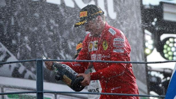 Charles Leclerc festeggia sul podio la vittoria al Gp di Monza. Lapresse