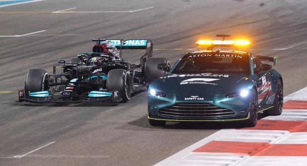 Mercedes' British driver Lewis Hamilton drives behind the safety car at the Yas Marina Circuit during the Abu Dhabi Formula One Grand Prix on December 12, 2021. (Photo by Giuseppe CACACE / AFP)