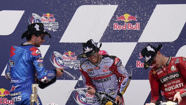 Enea Bastianini, center, of Italy, celebrates after winning the MotoGP Grand Prix of the Americas motorcycle race at the Circuit of the Americas, Sunday, April 10, 2022, in Austin, Texas. Alex Rins, left, of Spain, finished second, and Jack Miller, right, of Australia, finished third. (AP Photo/Eric Gay)