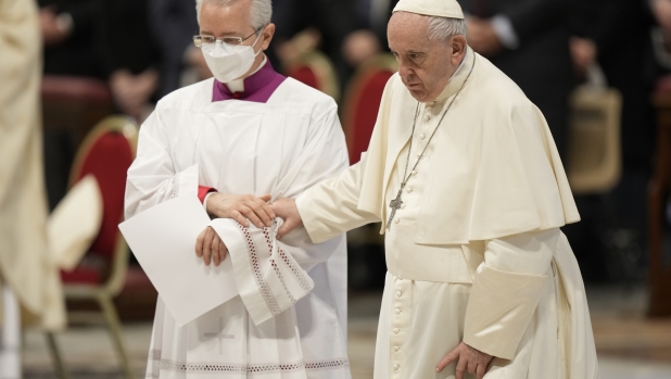 Pope Francis is helped by his aid Monsignor Diego Ravelli as he presides over a Mass for the Divine Mercy, in St. Peter's Basilica, Sunday, April 24, 2022. (AP Photo/Andrew Medichini)