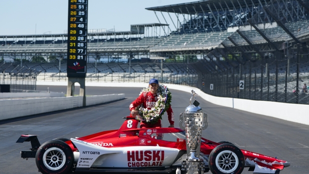 Marcus Ericsson, of Sweden, poses with the Borg-Warner Trophy during the traditional winners photo session at Indianapolis Motor Speedway in Indianapolis, Monday, May 30, 2022. Ericsson won the 106th running of the Indianapolis 500 auto race on Sunday. (AP Photo/Michael Conroy)