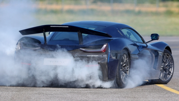 Driver Miroslav Zrncevic drifts with Croatian electric supercar Rimac Nevera on asphalt during the event "Fly over Rimac Nevera" at local airport in town Varazdin, in northern Coratia, on June 11, 2022. (Photo by Damir Sencar / AFP)