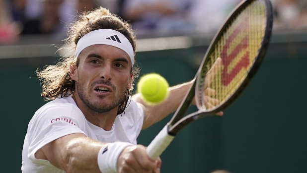 Stefanos Tsitsipas of Greece returns to Austria's Dominic Thiem in a first round men's singles match on day three of the Wimbledon tennis championships in London, Wednesday, July 5, 2023. (AP Photo/Alberto Pezzali)